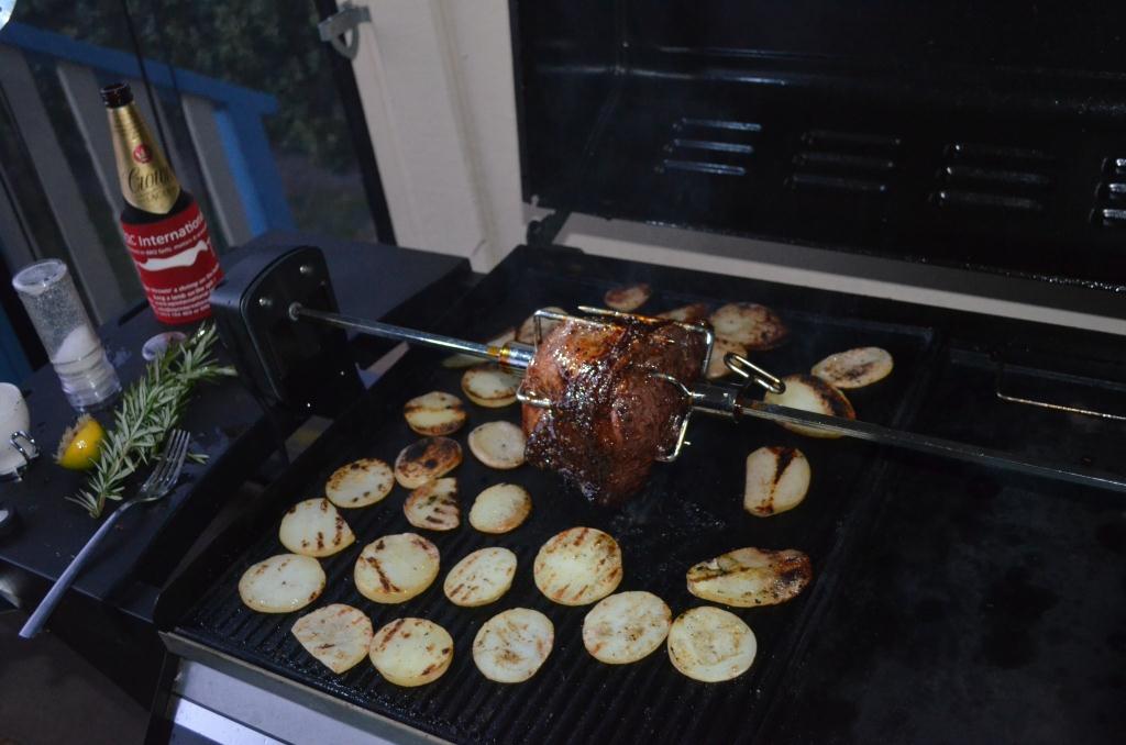 This is a picture of roast beef being cooked on a rotisserie kit on a gas BBQ